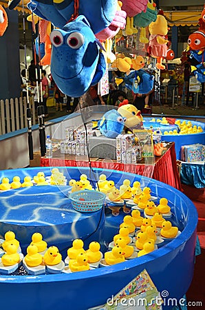 Fishing game of yellow ducks at the carnival Editorial Stock Photo