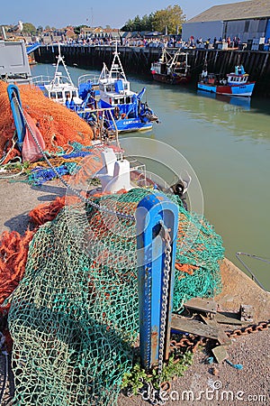 WHITSTABLE, UK - OCTOBER 15, 2017: The fishing Harbor with colorful fishing nets in the foreground Editorial Stock Photo
