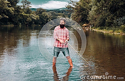 Fishing hobby and summer weekend. Bearded men fisher with fishing rod and net. Stock Photo