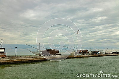 fishing huts between canal and adriatic sea in Cesenatico Editorial Stock Photo