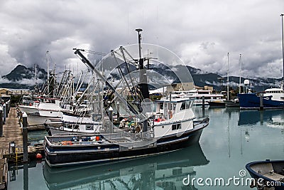 Fishing industrial trawler ships parked in marina pier in Valdez, Alaska. Editorial Stock Photo