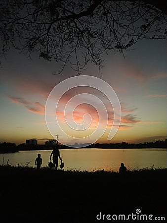 fishing by the lake until dusk falls Stock Photo