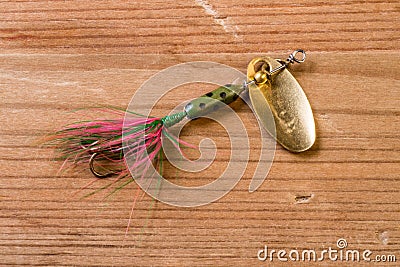 Fishing lure with bright colors on a wooden background Stock Photo