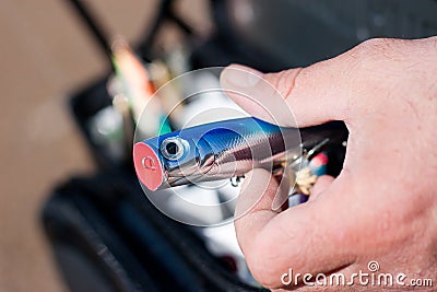 Fishing lure in fisherman hand Stock Photo