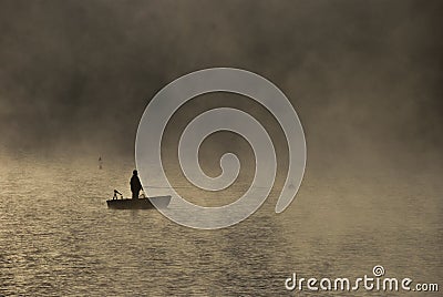 Fishing in the morning mist Stock Photo