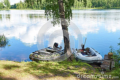 Fishing motor boats on coast of lake Stock Photo