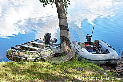Fishing motor boats on coast of lake Stock Photo