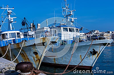 Fishing motorboats tied to mooring cleats Stock Photo