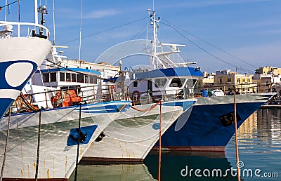 Fishing motorboats tied to mooring cleats Stock Photo