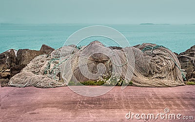 Fishing net on concrete floor. Stock Photo