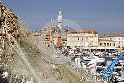 Fishing nets and motor boats in Rovinj harbour Stock Photo