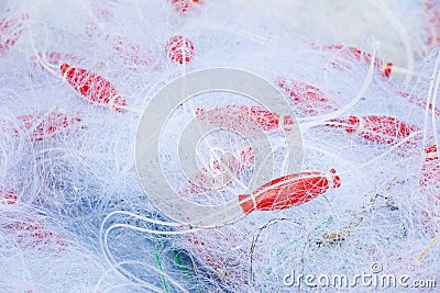 Fishing nets in a pile mixed with red floaters Stock Photo