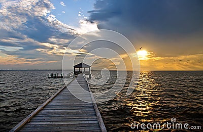 Fishing pier and dock at sunset Stock Photo