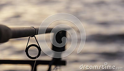 Fishing pole at sunset Stock Photo