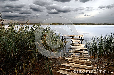 Fishing pond under stormy clouds Stock Photo