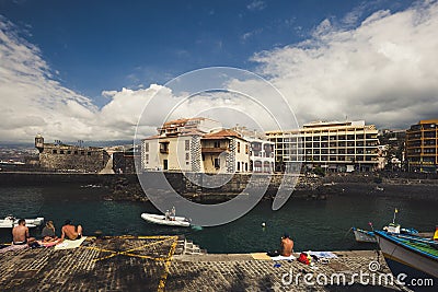 Fishing port with swimming and sunbathing people in Puerto de La Cruz, Tenerife, Spain Editorial Stock Photo