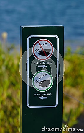 Fishing prohibited and Fishing permitted sign Stock Photo