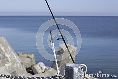 Fishing road leaned on the chains Stock Photo