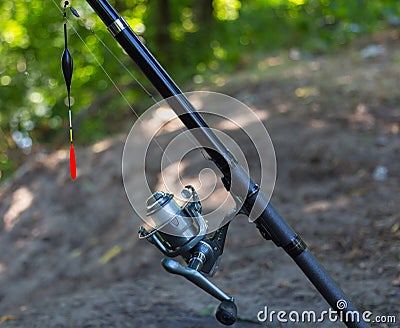 Fishing rod with inertialess reel and float. Stock Photo