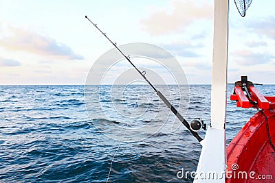 Fishing rod are prepared to offshore fishing on the boat in ocean Stock Photo