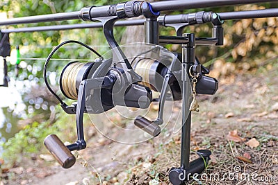 Fishing rod and reel for catching fish close-up on a blurry background. Stock Photo