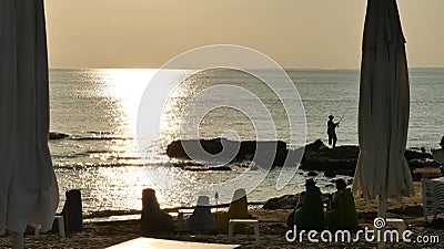 Fishing by the sea at sunset Editorial Stock Photo