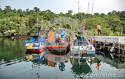 Fishing service boats wait for tourists in a pier on Koh Kood, Trat Province, Thailand Editorial Stock Photo