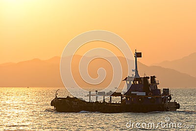 Fishing ship on the water in the sunset. Hong Kong, Asia Stock Photo