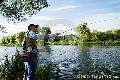 Fishing spinning on a beautiful river Stock Photo