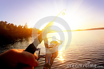 Fishing at sunset Stock Photo