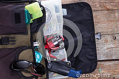 Fishing tackles and lures in open handbag Stock Photo