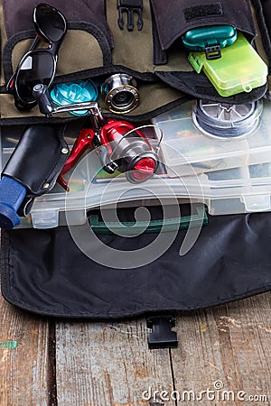 Fishing tackles and lures in open handbag Stock Photo