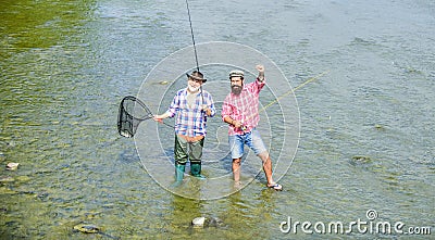 Fishing team. Male friendship. Father and son fishing. Summer weekend. Fishing together. Men stand in water. Nice catch Stock Photo
