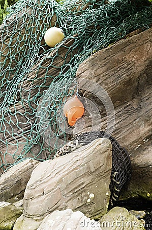 Fishing Trawl net over rocks Stock Photo