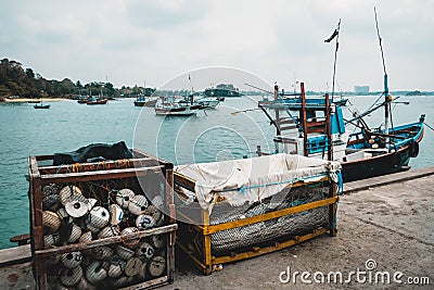 Fishing trawler and various equipment at a pier. Trawling as a traditional local craftsmanship in Sri Lanka. Fishing accessories: Stock Photo