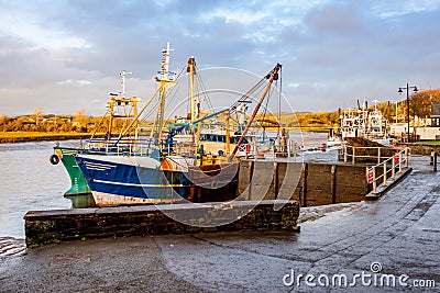 Fishing trawlers moored at Kirkcudbright harbour on the River Dee at sunset Editorial Stock Photo