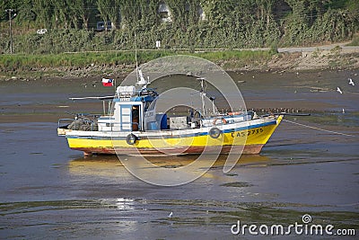 Fishing vessel on low tide, Chiloe Island, Chile Editorial Stock Photo