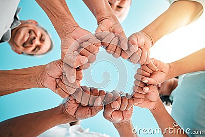 Fist, hands circle and below group of family, men and women for support, motivation or love. People, happy and hand Stock Photo