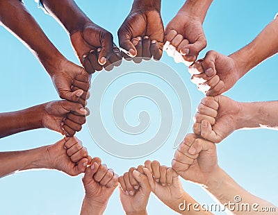 Fist hands, circle and diversity support human rights people, protest group and freedom of racism on blue sky background Stock Photo