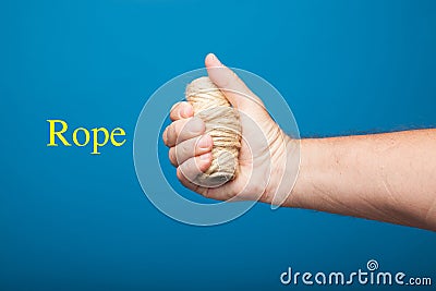 Fist of the right hand with rope Stock Photo