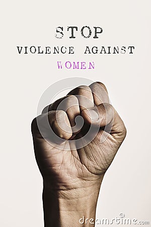 Fist and text stop violence against women Stock Photo