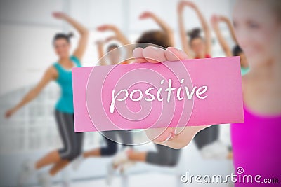 Fit blonde holding card saying positive Stock Photo