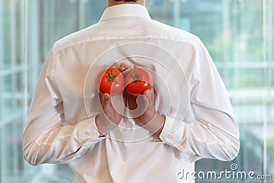 Fit business man with tomatoes as a healhy snack Stock Photo