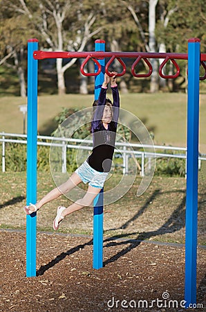 Fit child on monkey bars Stock Photo