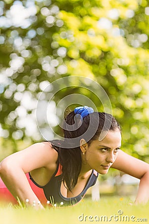 Fit determined brunette doing push ups Stock Photo
