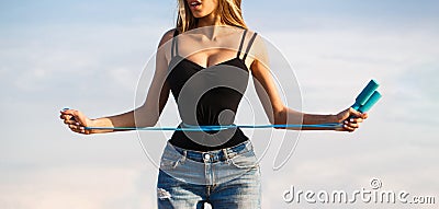 Fit fitness girl measuring her waistline with measure tape. Athletic slim woman measuring her waist by measure tape Stock Photo