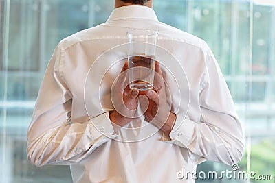 Fit flexible business man with glass of water Stock Photo
