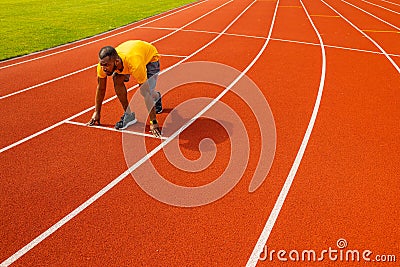 Fit focused confident african american runner sportsman in trendy sportswear standing in starting position ready to run Stock Photo