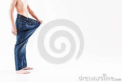 Fit guy standing in oversized jeans Stock Photo