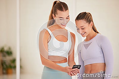 Fit, happy and athletic women laughing at funny social media posts on a phone before exercising together. Young athletes Stock Photo